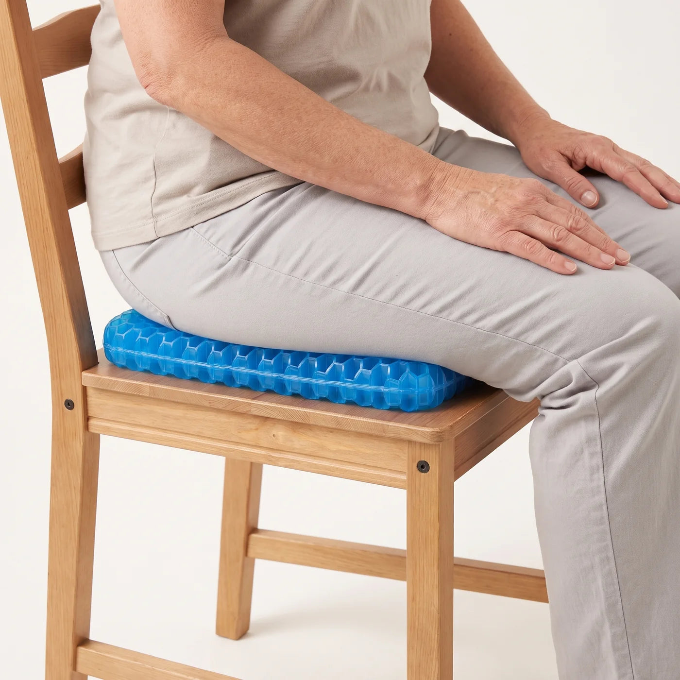 CellGel+ blue gel cushion supporting a seated person on a dining chair